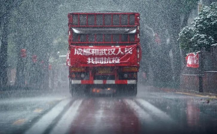↑ 2月15日，风雪中，运送成都市成华区捐赠武汉消毒液的卡车在市区行驶。